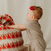 Baby mit roter Haarschleife für Weihnachten