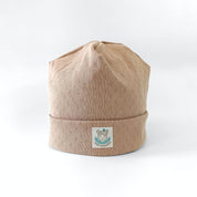 Beanie aus weicher Baumwolle mit feinem Lochmuster für Babys und Kinder in beige