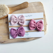 drei Haarschleifen für Babys in hellrosa, rosa und lila