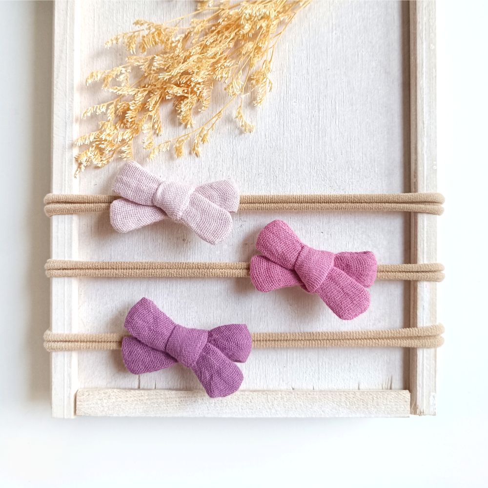 Haarschleifen für Babys in den Farben hellrosa, rosa und lila